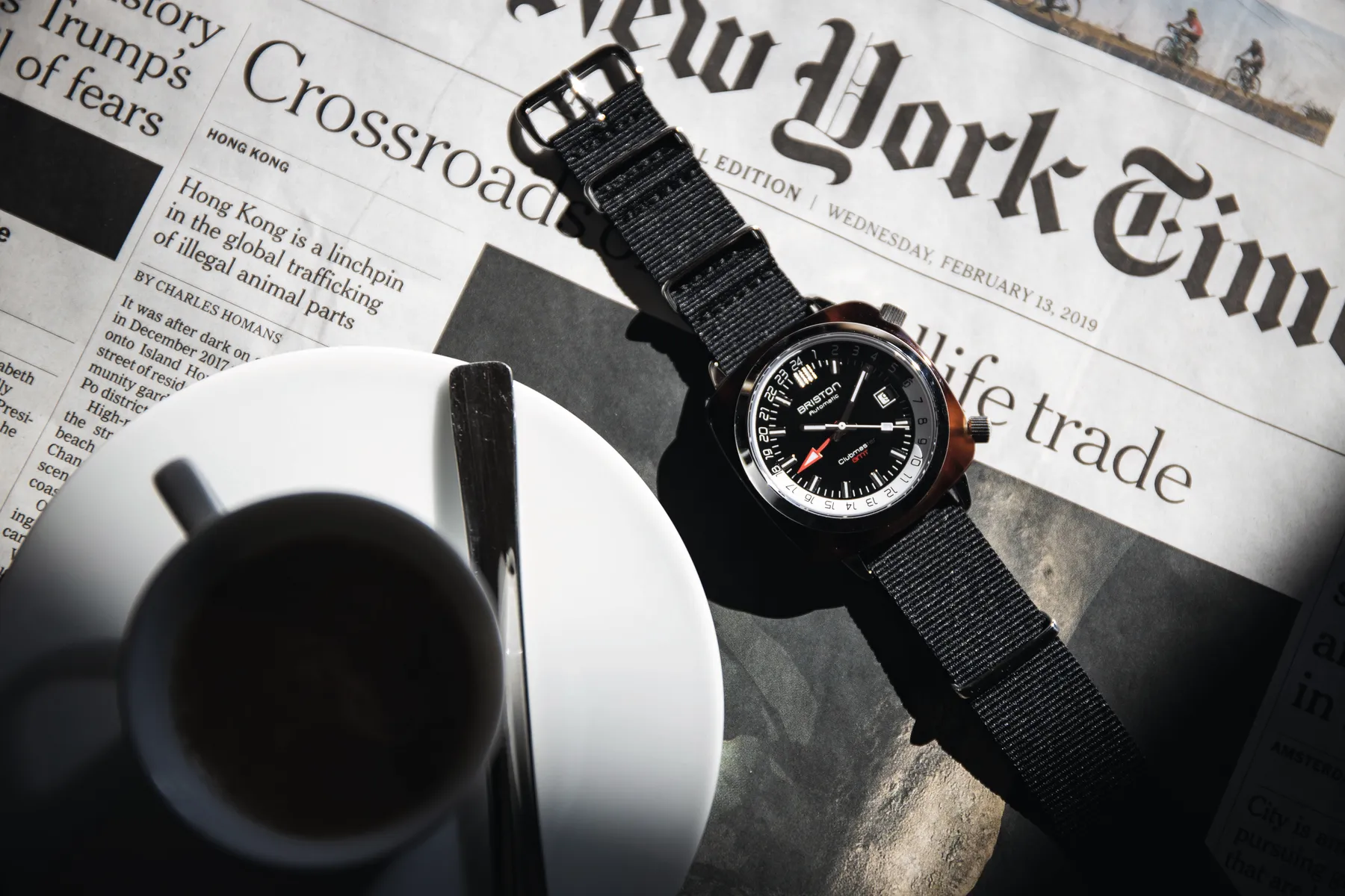 Briston GMT on the wrist of a driver holding a classic car steering wheel