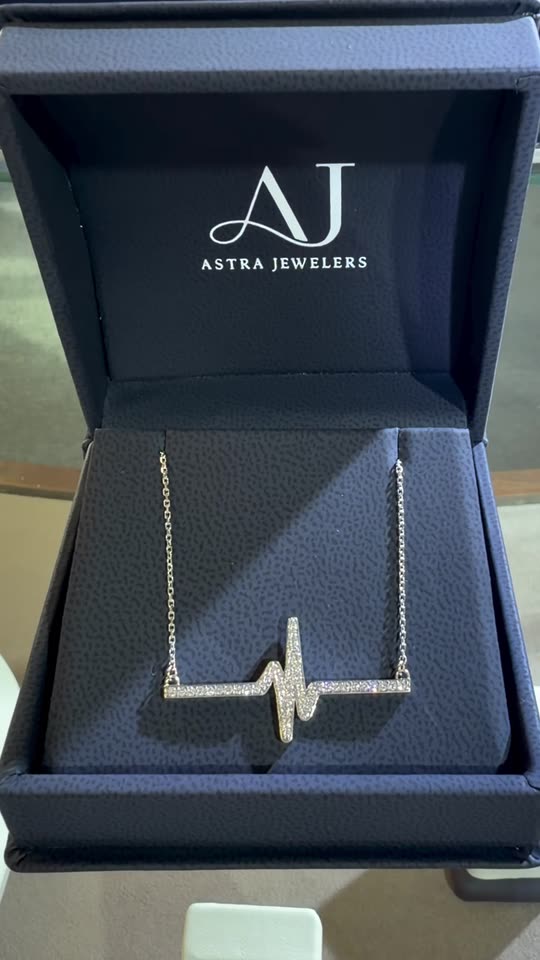 A custom diamond heartbeat pendant in an Astra Jewelers box