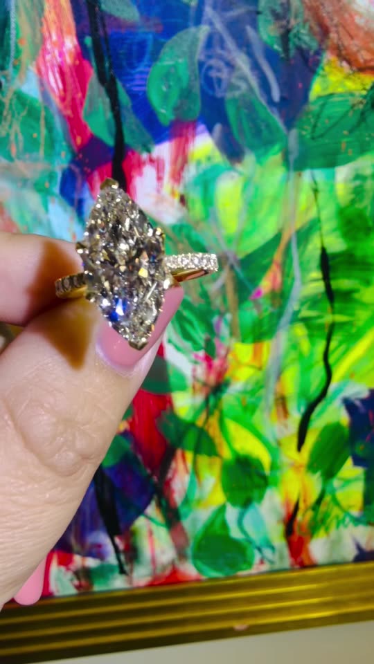A custom marquise diamond engagement ring in yellow gold