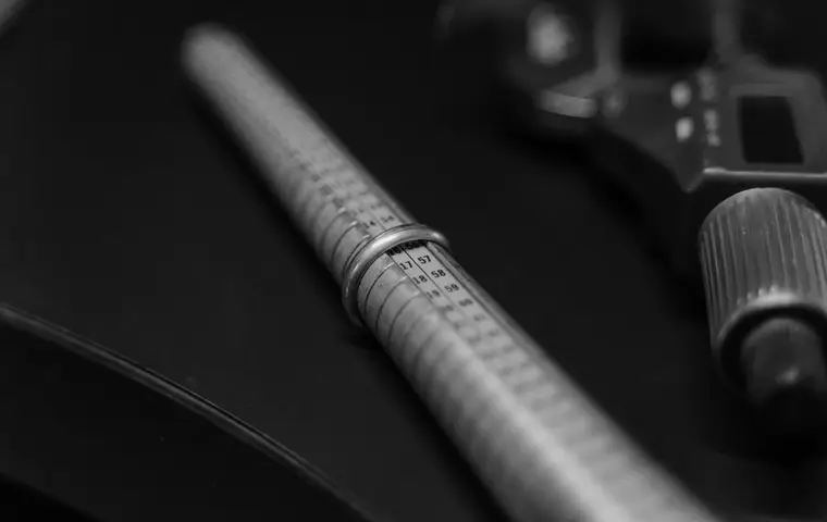 A ring sizer marked in millimeters beside a gauge