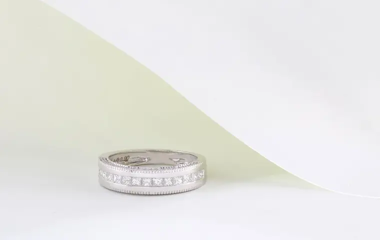 A white metal band set with small diamonds