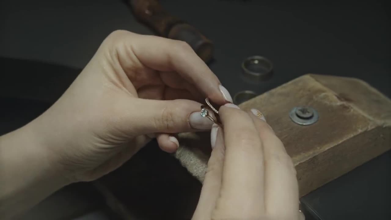 A jeweler measuring a ring at a workbench